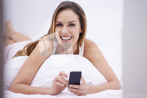 Image of Woman, bedroom portrait and phone for social media, search online and communication or streaming at home. Happy person relax on her bed with mobile for chat, contact and internet connection or break