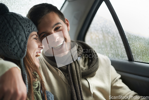 Image of Love, raining and couple in car for road trip together, laughing on date for travel, vacation or romance. Smile, winter or weather with man and woman in backseat of taxi for holiday trip or journey