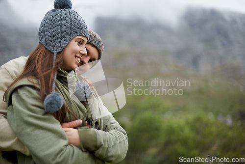 Image of Couple, hug and smile on hiking vacation in outdoors, love and bonding in relationship for connection. People, embrace and travel for exploring adventure, romance and security in marriage on mountain