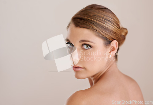 Image of Portrait, natural beauty and skincare of woman in studio isolated on a brown background mockup space. Face, serious and young model in cosmetics, healthy glow and spa facial treatment dermatology