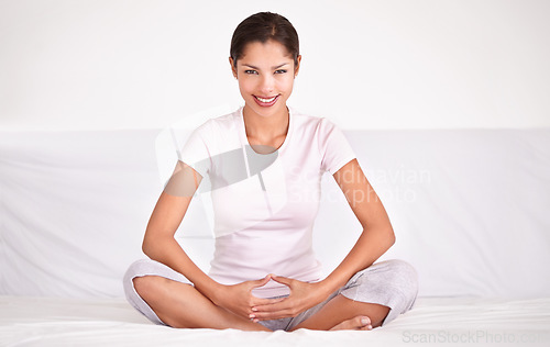 Image of Smile, calm and portrait of woman with meditation for peace, zen and mindful wellness on bed. Happy, health and young female person in position for spiritual balance in bedroom at apartment.