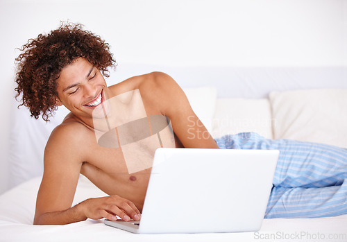 Image of Laptop, bedroom and relax man laughing at funny communication, social media meme and reading morning news. Comedy joke, network connection and person search internet for meme on home bed