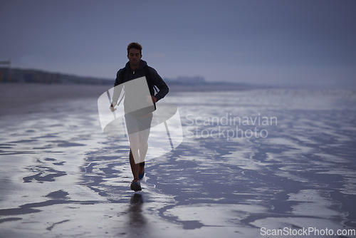 Image of Running, beach and man with fitness travel and exercise with wellness, explore and ocean. Person, runner and guy with fun, water and sunset with break and breathing with workout, energy and Miami