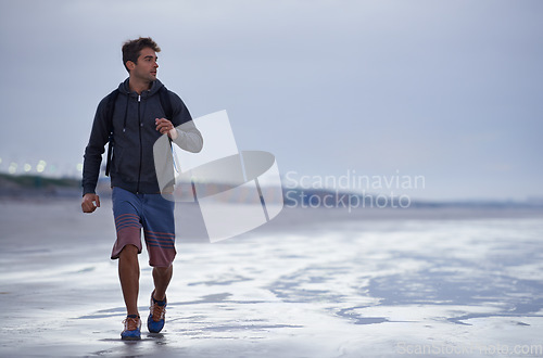 Image of Running, beach and man with vacation, health and exercise with nature, energy and ocean. Person, runner and guy with fun, water and sunset with wellness and explore with workout, cardio and Miami.