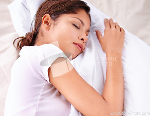 Image of Sleep, pillow and woman relax in bed for comfort, cozy nap and rest for stress relief in home apartment. Eyes closed, exhausted and top view of sleeping person with burnout, tired or bedroom dream