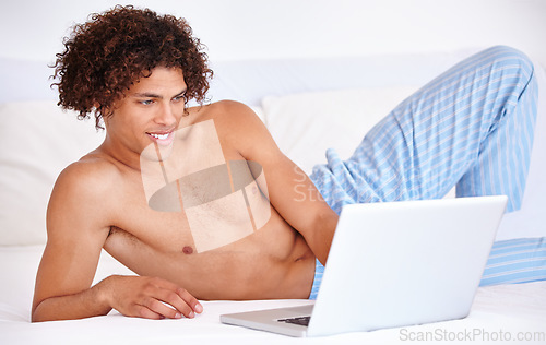 Image of Man, laptop and relaxing in bed on website, blog and subscription for movie at home. Male person, download and internet connection for online entertainment, search and scroll on streaming service