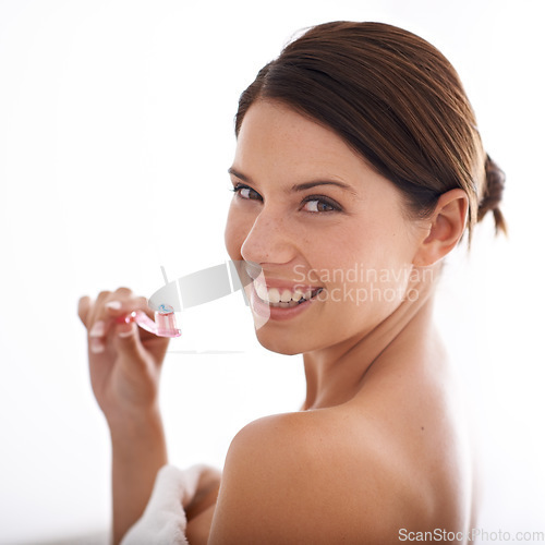 Image of Toothbrush, smile and portrait of woman on a white background for dental care, oral hygiene or cleaning. Healthcare, whitening and face of person brushing teeth with toothpaste for wellness in studio