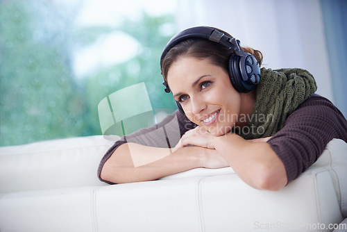 Image of Relax, smile and woman with music headphones on a sofa streaming, listening or chilling at home. Happy, thinking and female person in a living room with earphones for radio, audio or playlist track