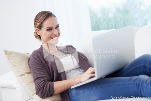 Image of Woman, remote work and laptop to relax on sofa for blog post, social media or reading digital research. Happy freelancer, computer or download movie subscription, online shopping or elearning at home