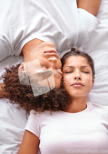 Image of Sleeping, duvet and face of couple in bedroom for comfort, cozy nap and rest with eyes closed in Puerto Rico home. Bed, fatigue and top view of man, woman or people sleep with calm, peace or wellness