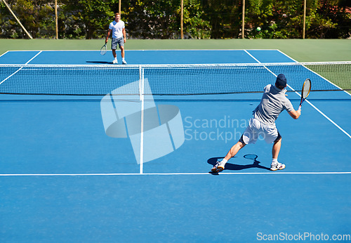 Image of Tennis, match and men with fitness, sports and competition with training and cardio with a game. Players, friends and guys with rackets and court with workout and sunshine with challenge and practice