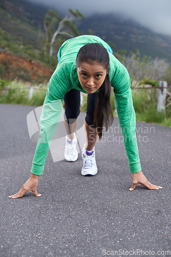 Image of Woman, on her mark and start run for fitness, race or marathon with athlete training outdoor. Runner is ready, portrait and exercise, cardio and speed with challenge, sports for health and wellness