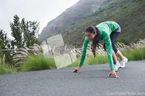 Image of Woman, on her mark and start running for fitness, race or marathon with athlete training outdoor. Runner is ready for exercise, cardio and speed with challenge, sports for health and wellness