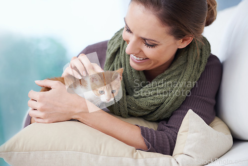 Image of Happy, sofa and woman with kitten in home for bonding, friendship and relax together in house. Animal care, pets and person with adorable, cute and young cat on couch for playing, affection and love