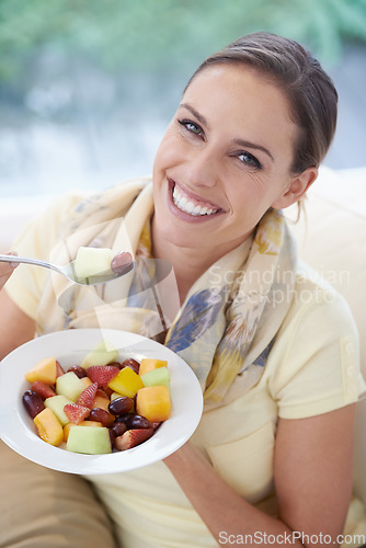 Image of Healthy food, happy woman in portrait and fruit in salad for diet, organic meal and relax on sofa with smile for weight loss. Vegan, gut health and wellness, eating for nutrition with vitamins