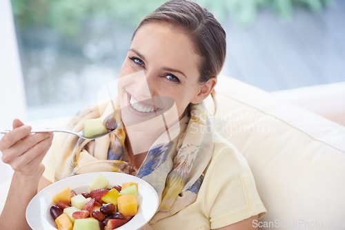 Image of Food, happy woman in portrait and fruit in salad for diet, organic meal and relax on sofa with smile for weight loss. Vegan, gut health and wellness, healthy eating for nutrition with vitamins