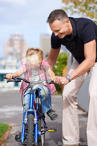 Image of Bicycle, teaching and father with boy child in a road for help, learning or outdoor ride together. Love, family or parent with kid in a street for cycling assistance, bonding and support or safety