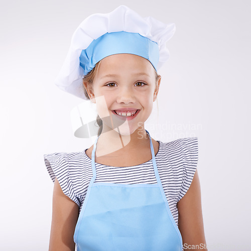 Image of Kid, chef and portrait with apron, confident and child development on white background. Culinary skills, happy and ready to cook, food and childhood growth with confidence in hospitality industry