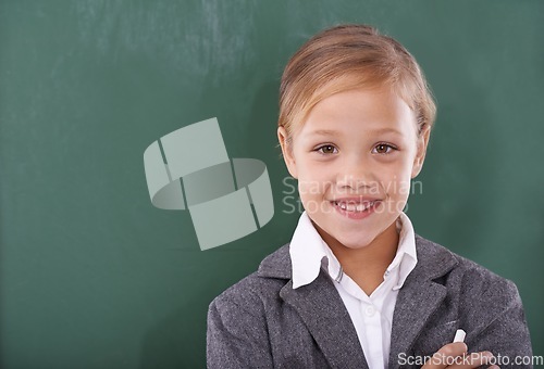 Image of Child, portrait and chalkboard for school education in classroom for learning, writing or homework. Female person, uniform and kindergarten development or brainstorming or knowledge, study or mockup