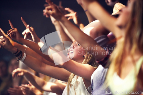 Image of Night, concert and fans dance to music, performance and audience with energy at festival. Crowd, support and people stretching hands in celebration or praise of rock, culture or excited at event