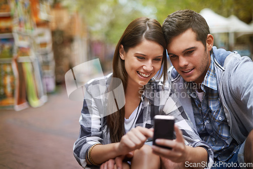 Image of City, smile and couple with a cellphone, internet and social media with texting, digital app or meme. New York, man or woman with a smartphone, mobile user or connection with network, joy or marriage