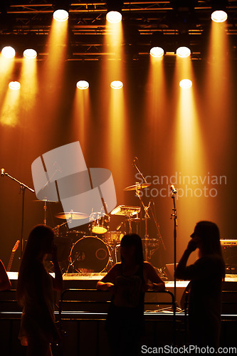 Image of Silhouette, band and playing at stage for concert, spotlight and instruments for music festival. Musician, singing and sound entertainment by event equipment by technology and audio performance