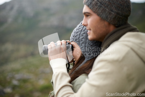 Image of Binoculars, nature and couple on mountains for journey, adventure and hiking or explore on carbon footprint travel. Love with man and woman in outdoor gear for birdwatching, winter tourism and search