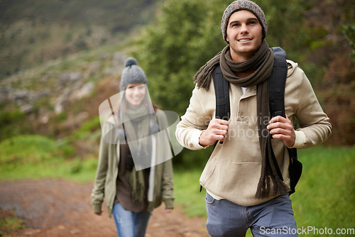 Image of Couple, smile and hiking in forest or nature with travel, adventure or holiday for experience or fitness. Man, woman or trekking outdoor in woods for cardio, exercise or workout with care or backpack