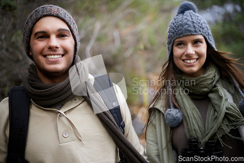 Image of Couple, happy and hiking in forest or nature for travel, adventure or holiday for experience or fitness. Man, woman and trekking outdoor in woods for cardio, exercise or workout with care or backpack