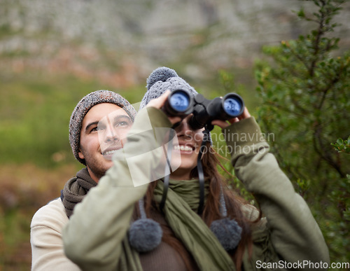 Image of Couple, love and binocular in nature for travel, adventure or hiking journey and explore together in eco friendly mountains. Happy man and woman trekking with outdoor search, vision or birdwatching