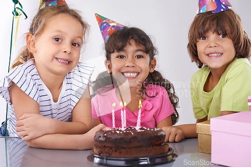 Image of Friends, kids and birthday cake, party and candles with happy people for celebration, youth and dessert. Special day, together in festive mood and children smile for social event with chocolate