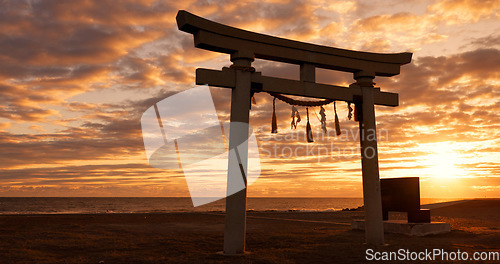 Image of Torii gate, sunset sky in Japan with clouds, zen and spiritual history on travel adventure. Shinto architecture, Asian culture and calm nature on Japanese landscape with sacred monument at shrine.