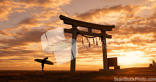 Image of Torii gate, sunset and man with surfboard bowing, ocean and travel adventure in Japan with orange sky. Shinto architecture, Asian culture and calm beach in Japanese nature with person at spiritual mo
