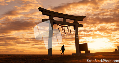 Image of Torii gate, sunset sky and man at ocean with surfboard, spiritual history and travel adventure in Japan. Shinto architecture, Asian culture and calm beach in Japanese nature with sacred monument.