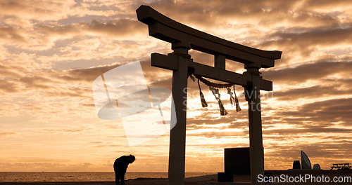 Image of Torii gate, sunset sky in Japan and man in silhouette with clouds, zen and spiritual history on travel adventure. Shinto architecture, Asian night culture and calm nature on Japanese sacred monument.