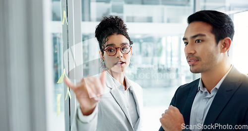 Image of Business people, planning and glass wall with point, talk and thinking with notes for problem solving. Partnership, man and woman with brainstorming, leadership and moodboard with choice for solution