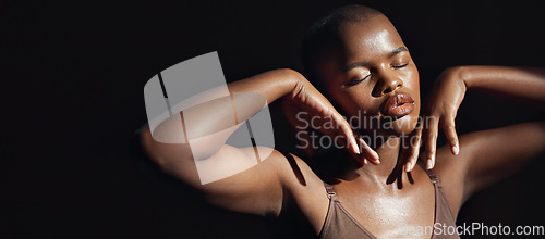 Image of Face, hands and beauty with a natural black woman on a dark background in studio for feminine wellness. Arms, skincare and aesthetic with a confident model touching her body or skin in satisfaction