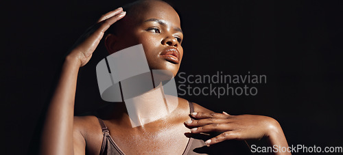 Image of Face, vision and beauty with a natural black woman on a dark background in studio for feminine wellness. Hands, skincare and thinking with a young model touching her body or skin in satisfaction