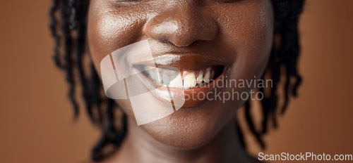 Image of Woman, teeth closeup or smile for dental care, oral hygiene or healthy wellness on brown background. Mouth, lips or face of a happy model in studio for tooth whitening, beauty or dentist treatment