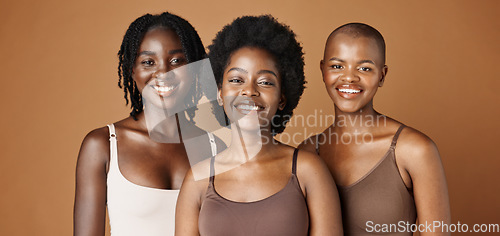 Image of Face, beauty and wellness with black woman friends in studio on a brown background for natural aesthetic. Portrait, skincare and smile with a group of african people looking happy or satisfied