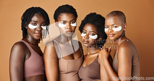 Image of Face, happy or black women with eye patch for skincare or beauty isolated on brown background. Studio, smile or African models with facial collagen pads, dermatology product or anti aging cosmetics