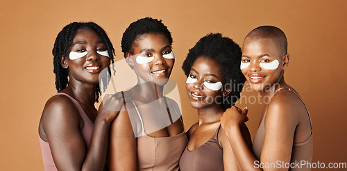 Image of Face, happy or black women with eye patch for skincare or beauty isolated on brown background. Studio, smile or African models with facial collagen pads, dermatology product or anti aging cosmetics