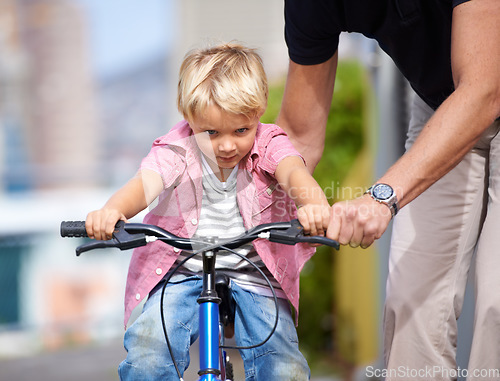 Image of Father, bike and teaching child to ride in outdoor, bonding together and wellness with childhood development. Parent, son and fun in nature for learning bicycle, love and care for cycling on vacation