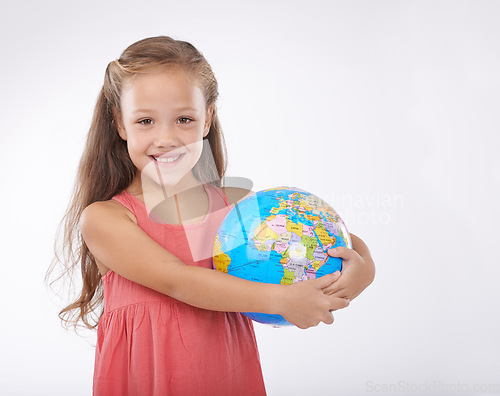 Image of Child, portrait and world globe for education school learning in studio for Geography, continents or white background. Girl, student and planet for class studying Earth population, travel or mockup