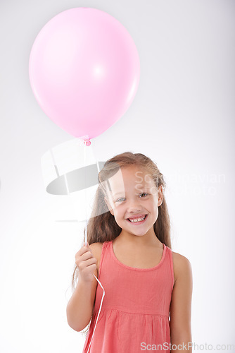 Image of Girl, child and balloon in portrait, party decoration and smiling for milestone event in studio. Happy female person, inflatable accessory and birthday joy on white background, playful and celebrate