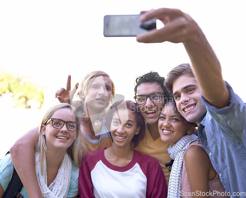 Image of Students, selfie and cellphone on campus with smile, together and wellness at university for online post. Friends, smartphone or diversity in education or study group in profile picture by outdoor