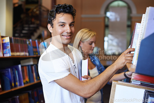Image of Portrait, book or student in a library to search at university, college or school campus for education. Bookshelf, learning or happy man with scholarship studying knowledge, research and information