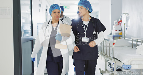 Image of Doctors, nurses and women walking, talking and planning healthcare, clinic management and workflow schedule. Medical worker, surgeon and mentor support, hospital teamwork and folder or patient charts