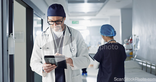 Image of Surgeon, doctor and tablet for hospital, healthcare or clinic research, online planning and schedule management. Medical professional typing on digital technology for surgery results, charts or data