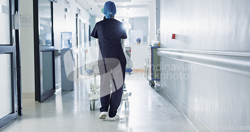 Image of Patient, bed and nurse walking in hospital, hallway or corridor to surgery, operation room or ER healthcare service. Doctor, moving and pushing person in clinic to ICU, bedroom or walk backward
